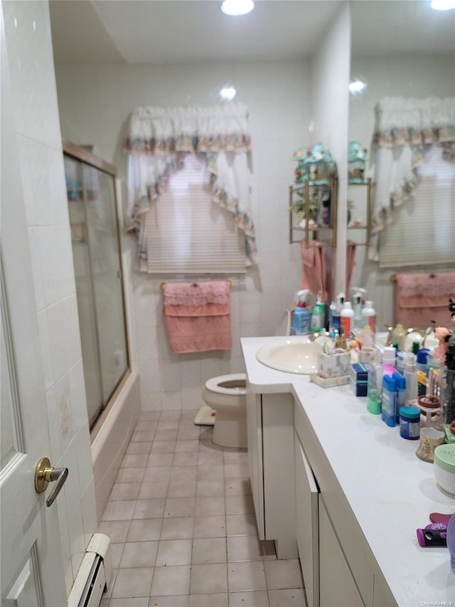 full bathroom with a baseboard radiator, tile patterned flooring, enclosed tub / shower combo, toilet, and vanity