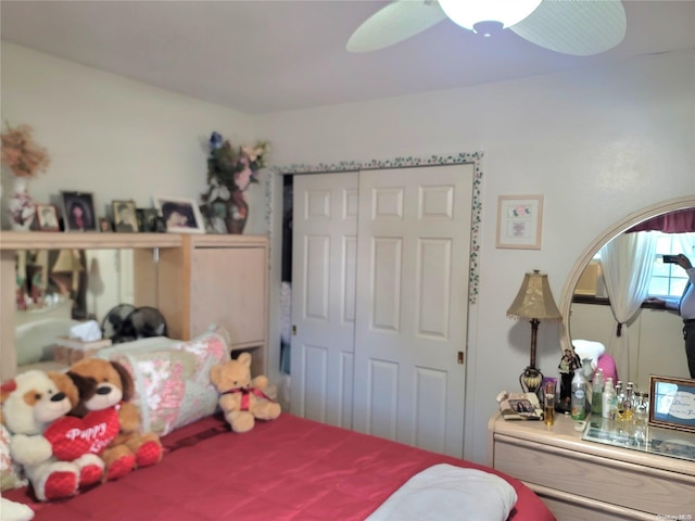 bedroom with ceiling fan and a closet