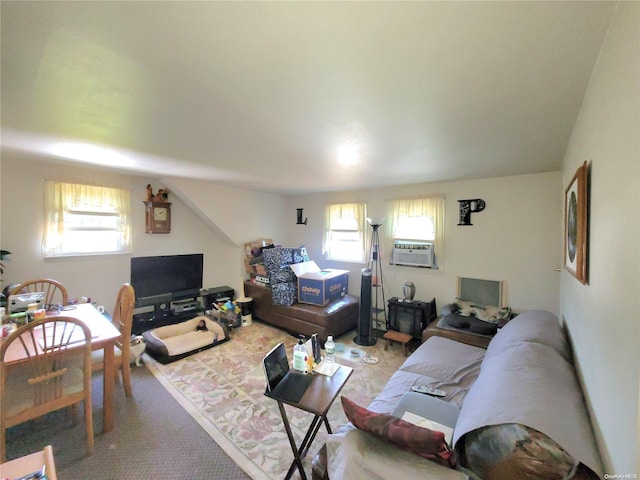 living room featuring light carpet, cooling unit, and a healthy amount of sunlight