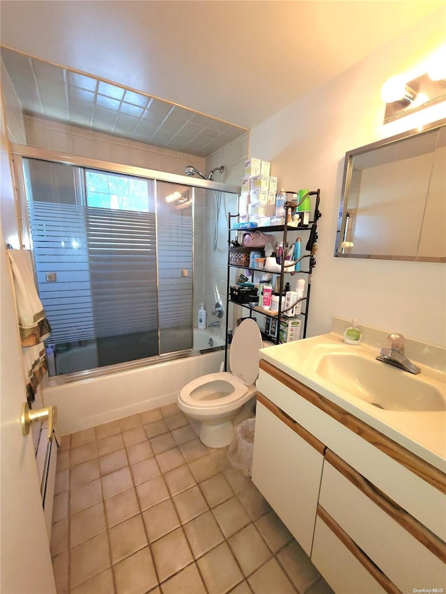 full bathroom with tile patterned flooring, vanity, enclosed tub / shower combo, and toilet