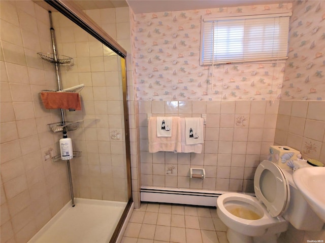 bathroom featuring a baseboard radiator, tile patterned flooring, an enclosed shower, toilet, and tile walls