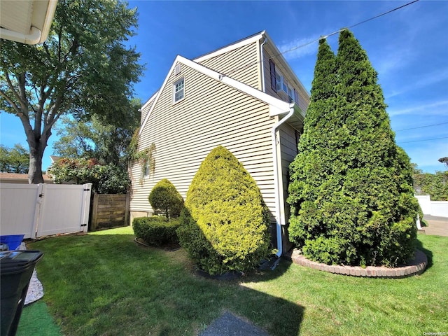 view of property exterior featuring a lawn