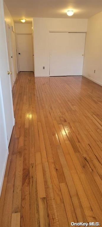 spare room with light wood-type flooring