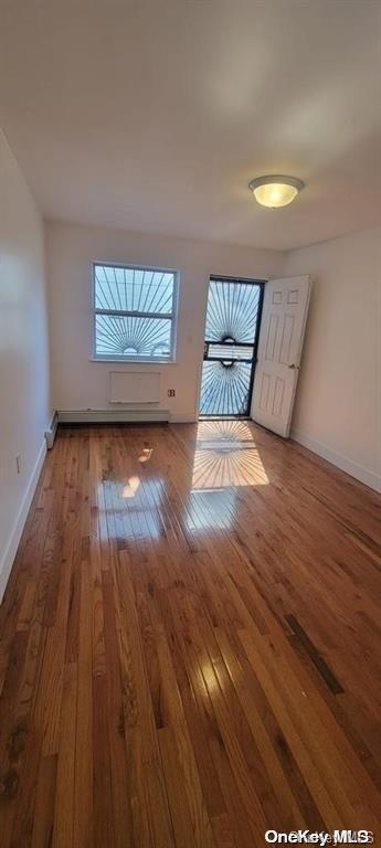 unfurnished room with hardwood / wood-style floors