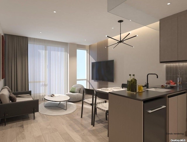 kitchen featuring gray cabinetry, sink, pendant lighting, light hardwood / wood-style flooring, and a notable chandelier