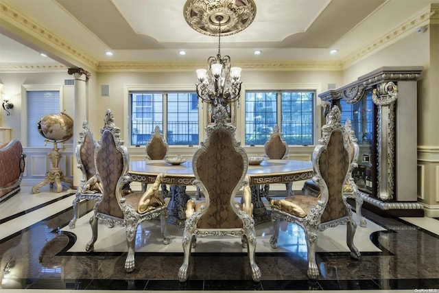 dining space with a tray ceiling, a healthy amount of sunlight, and an inviting chandelier