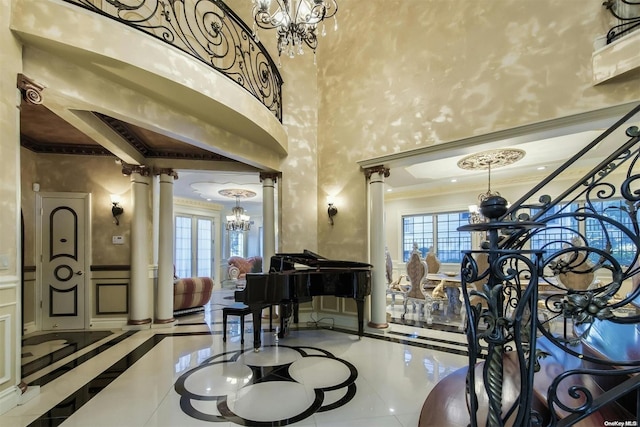 interior space with a high ceiling, decorative columns, tile patterned floors, and ornamental molding