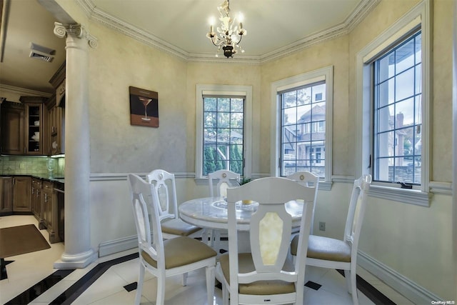 tiled dining area with a chandelier, ornate columns, and crown molding