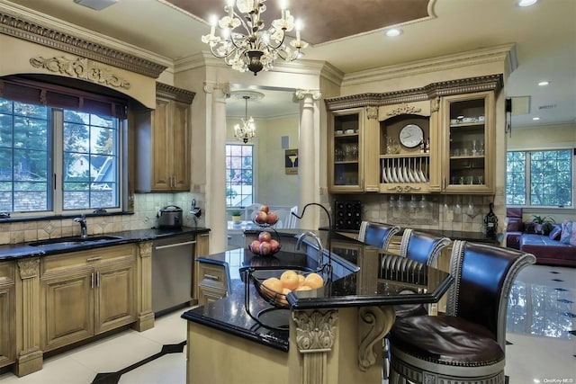 kitchen with dishwasher, sink, hanging light fixtures, a breakfast bar area, and decorative backsplash