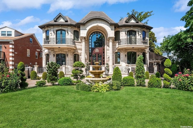 french country inspired facade with a front yard