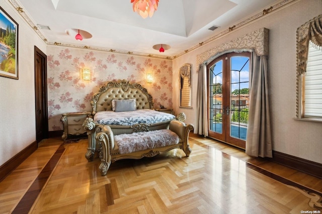 bedroom with a raised ceiling, access to exterior, french doors, and parquet flooring