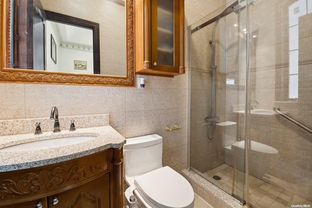 bathroom featuring toilet, vanity, tile walls, and walk in shower