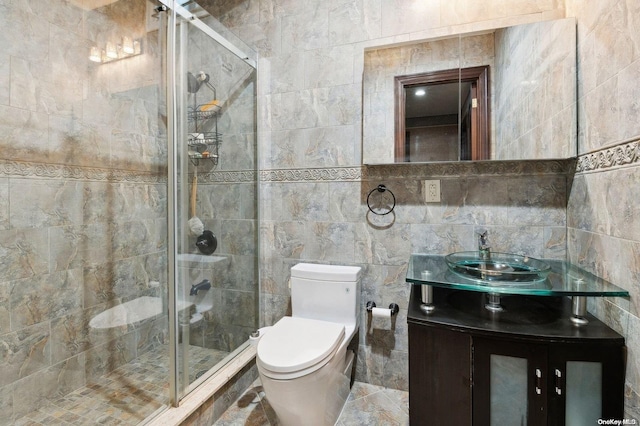 bathroom with walk in shower, vanity, tile walls, and toilet