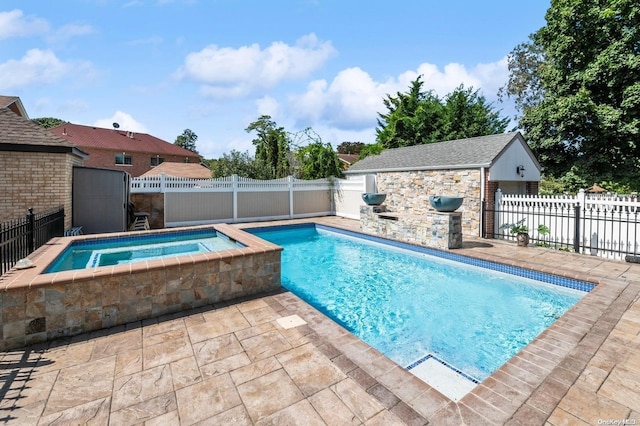 view of swimming pool featuring an in ground hot tub and an outdoor structure