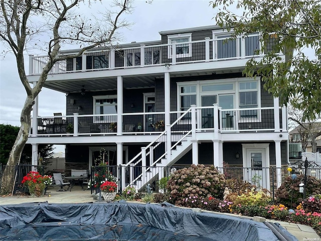 back of house with a patio area and a balcony