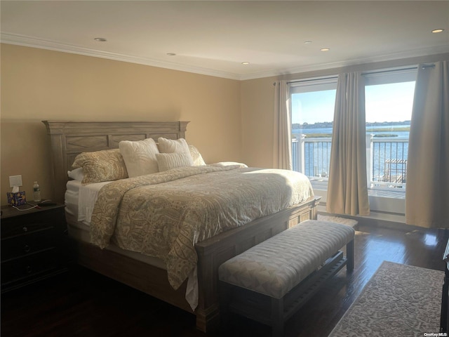 bedroom with ornamental molding, a water view, and dark wood-type flooring