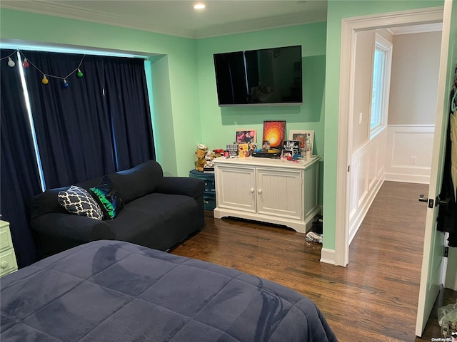 bedroom with dark hardwood / wood-style flooring and ornamental molding