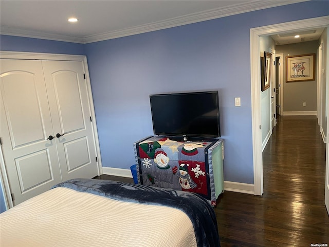 bedroom featuring a closet, dark hardwood / wood-style floors, and ornamental molding