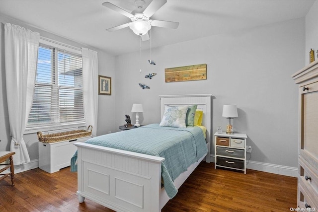 bedroom with dark hardwood / wood-style flooring and ceiling fan