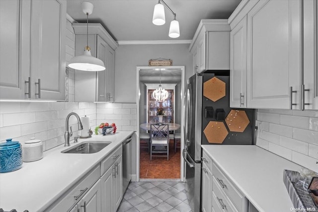 kitchen with pendant lighting, tasteful backsplash, ornamental molding, and sink