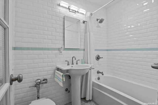 bathroom featuring shower / bath combo and tile walls