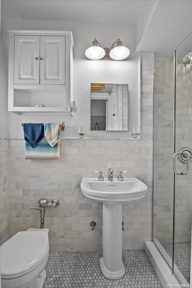 bathroom with tile patterned flooring, tile walls, and toilet