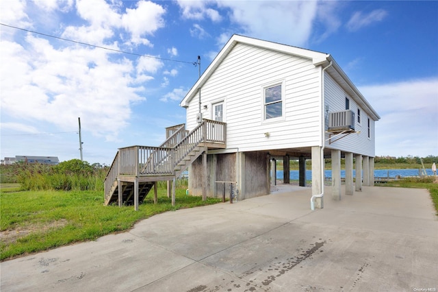 rear view of property featuring a carport and cooling unit