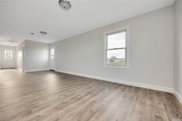 unfurnished room with light hardwood / wood-style floors