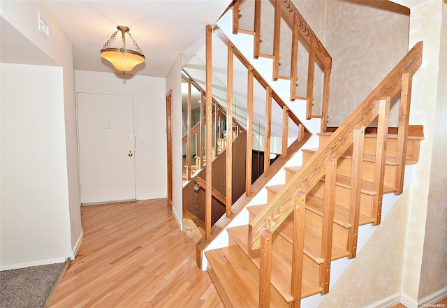 stairway with hardwood / wood-style floors