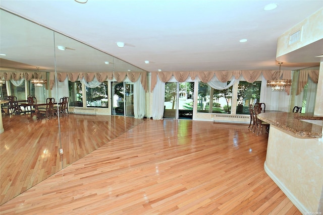 interior space with light hardwood / wood-style floors and a chandelier