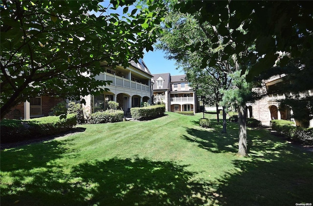 view of yard with a balcony