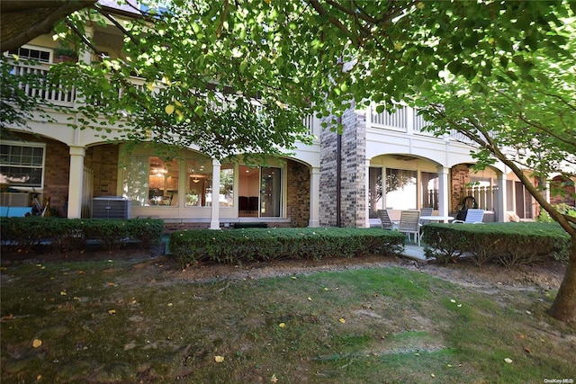 view of front of house with a balcony and cooling unit