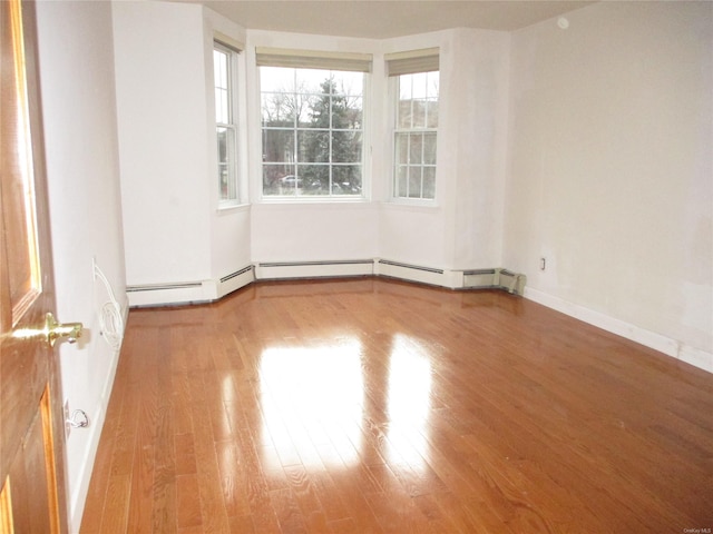 spare room with hardwood / wood-style floors