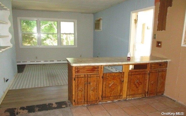 kitchen featuring light tile patterned floors and a baseboard radiator