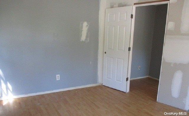 empty room with hardwood / wood-style floors