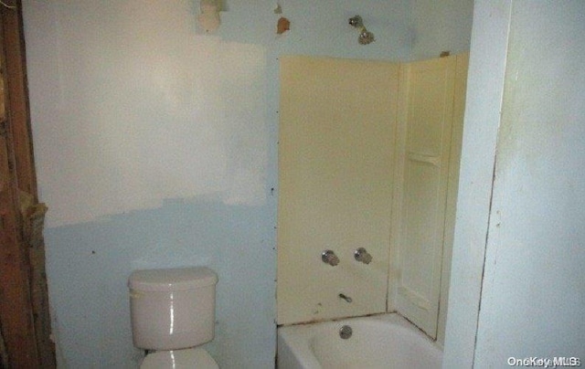 bathroom featuring a bath and toilet