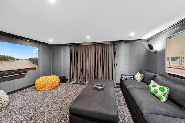 carpeted home theater room with crown molding