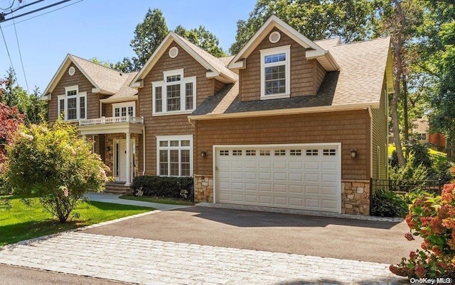 view of front of home featuring a garage and a balcony