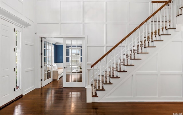 entryway with dark wood-type flooring and french doors