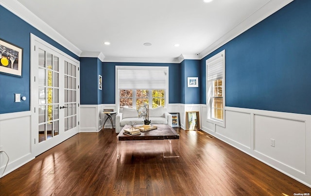 living area featuring wood-type flooring, french doors, and ornamental molding