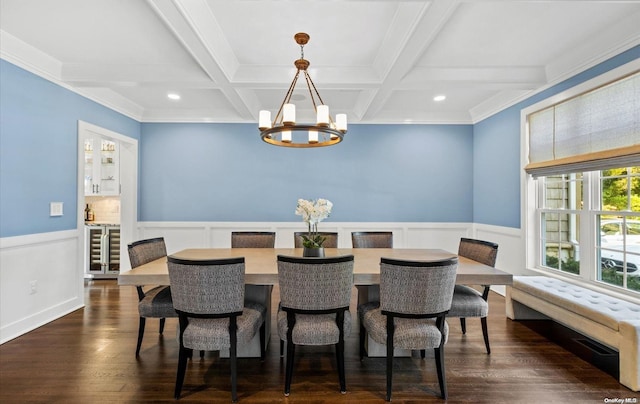 dining area with a chandelier, ornamental molding, dark hardwood / wood-style flooring, and beamed ceiling