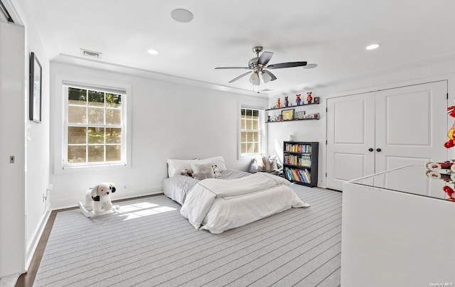 bedroom with ceiling fan and a closet