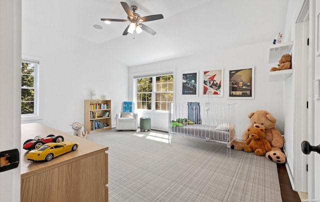 interior space with ceiling fan, wood-type flooring, and vaulted ceiling