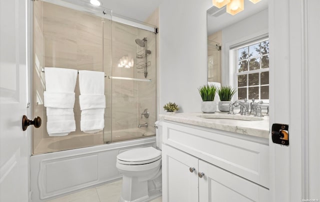 full bathroom with tile patterned floors, vanity, toilet, and enclosed tub / shower combo