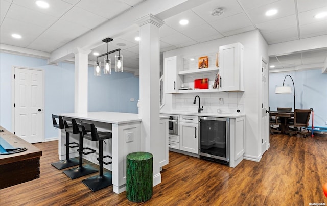 kitchen featuring dark hardwood / wood-style flooring and white cabinetry