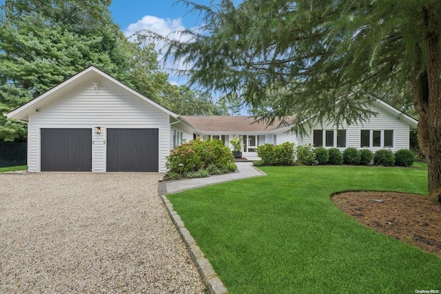 ranch-style house with a front yard and a garage