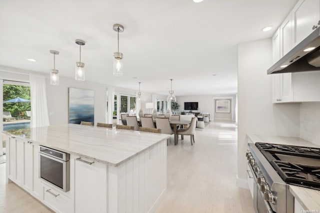 kitchen featuring a healthy amount of sunlight, white cabinetry, and stainless steel appliances