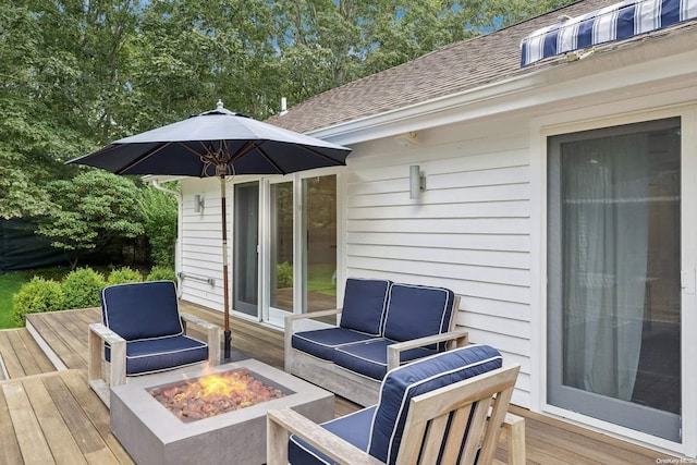 wooden deck with an outdoor living space with a fire pit