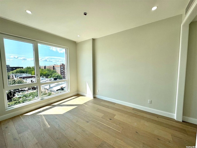 spare room with light hardwood / wood-style flooring