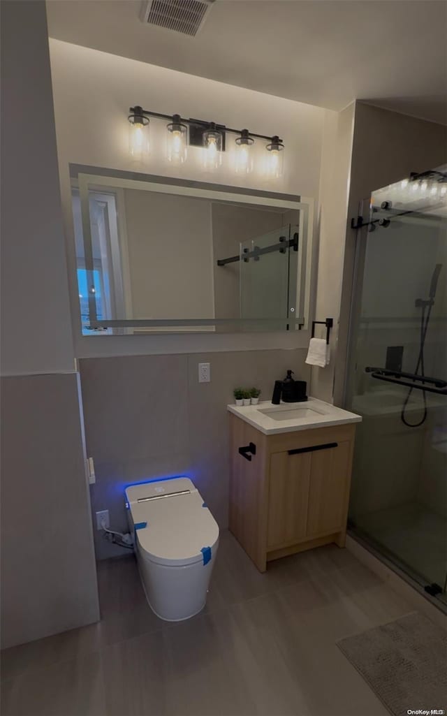 bathroom with vanity, toilet, wood-type flooring, and walk in shower